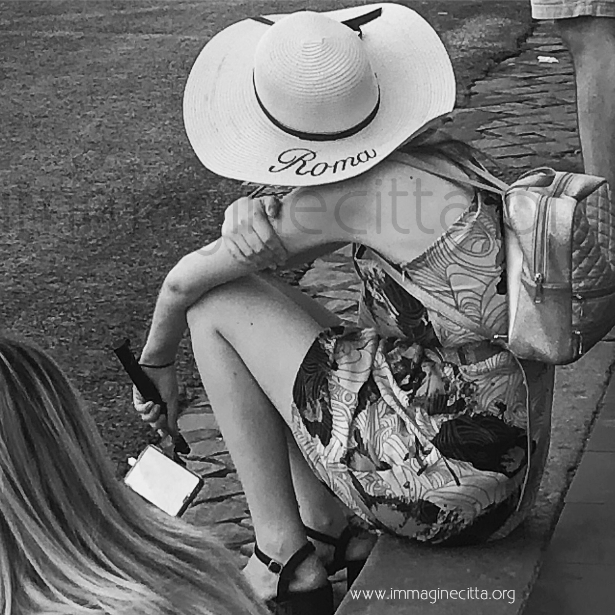 turista seduta alla fermata con il cappello con la scritta roma